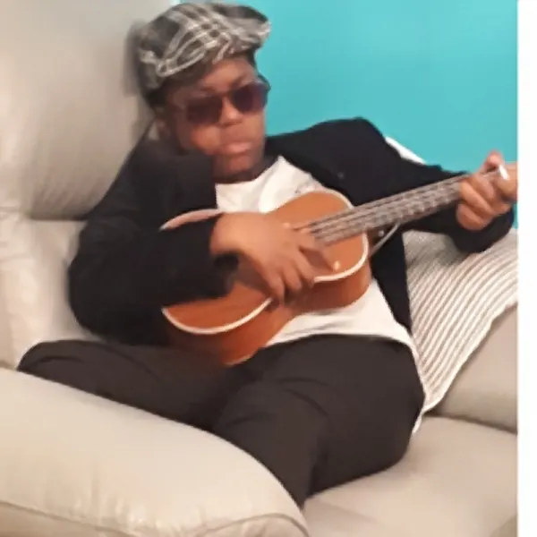 Aaron Brice, a ukulele student of guitar teacher Malcolm Callus in Rotherhithe, London