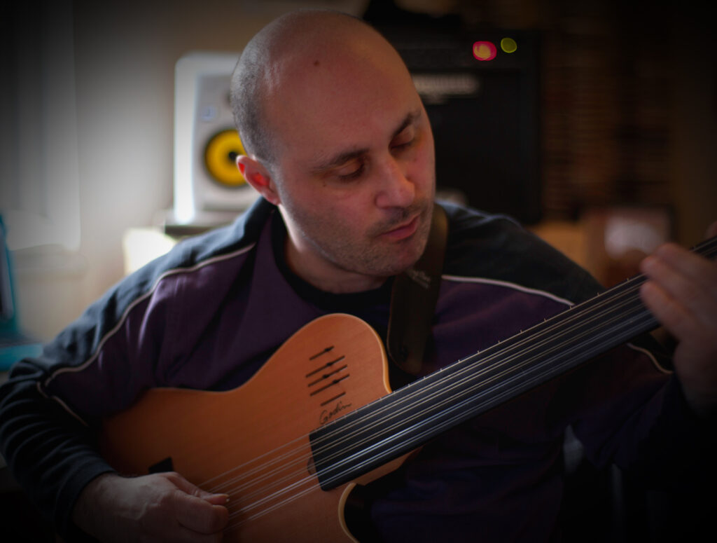 Malcolm Callus playing fretless bass in his Cool Gool studio, London SE16