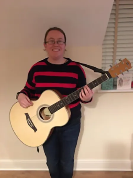Claire Reynolds with the acoustic guitar they play in lessons at Cool Gool Music, south east London