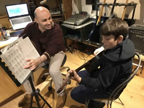 Cool Gool Music guitar student Ettore Caracci with their acoustic guitar, London SE16
