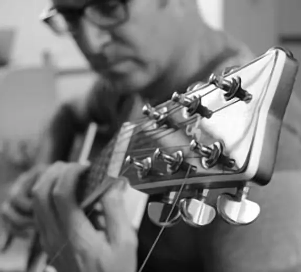John Ford holding their acoustic guitar — Cool Gool Music guitar lessons, London SE16