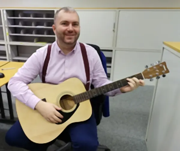 Cool Gool Music student Lucasz pictured with their acoustic guitar, south east London
