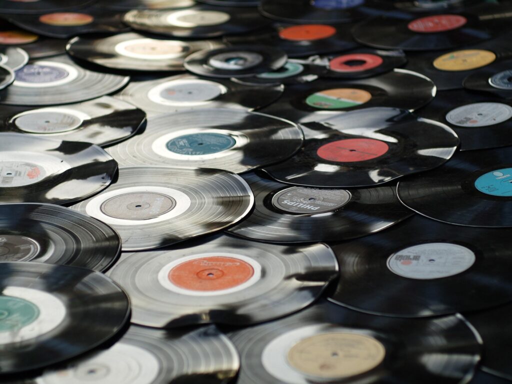 A spread of vinyl records catching the light