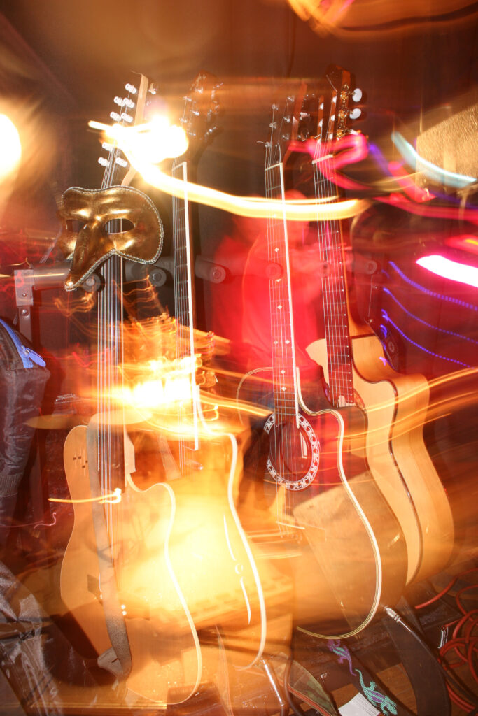 Guitars and stage gear caught in a long-exposure light trail